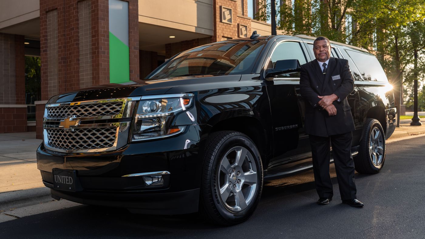 Black Chevrolet Suburban SUV with professional chauffeur